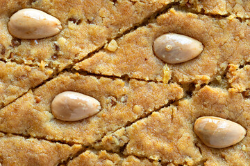 Close-up view of cake with almonds, fenugreek seeds and semolina. Palestinian helbeh cake. Dessert...