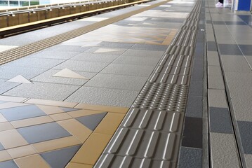 tactile paving for blind handicap on tiles pathway, walkway for blindness people located in train...