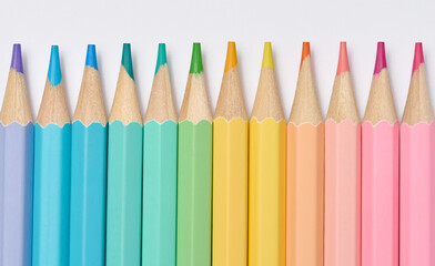 Multi-colored wooden pencils on a white background