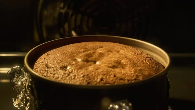 Homemade pie baked in oven, timelapse. Process of baking cake inside electric oven. Chocolate. Homemade bakery concept. Close-up view in 4k, UHD. Tasty food.