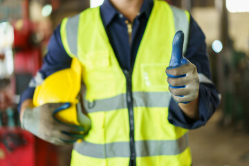 Senior caucasian white ethnicity factory foreman in factory portrait, man in safety suit looking and smiling to camera.