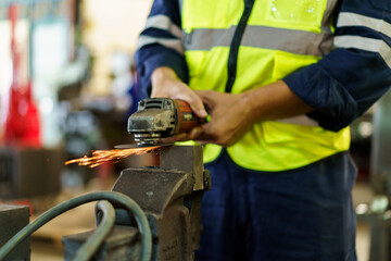 Professional metal work worker sharpening and grinding metal pipe. Man grinds metal profile in...