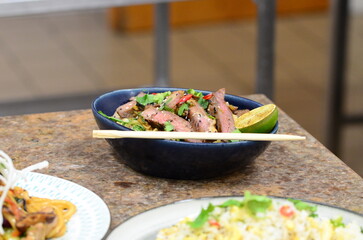 close up view of asian salad nam tok with noodles and beef	