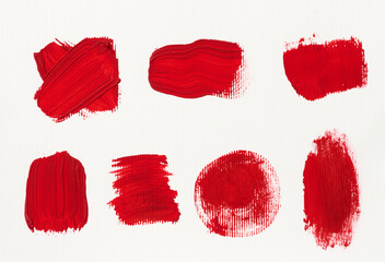Various strokes of red gouache paint on a white sheet of paper - obrazy, fototapety, plakaty