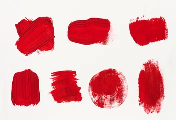 Fotobehang Various strokes of red gouache paint on a white sheet of paper © nndanko