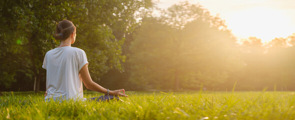 Young asian woman doing meditation in morning or evening at park, healthy woman relaxing and...