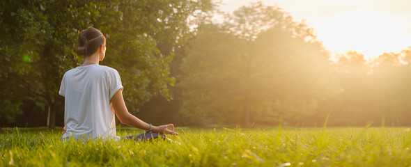 Young asian woman doing meditation in morning or evening at park, healthy woman relaxing and...