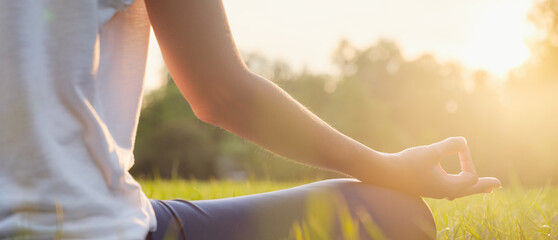 Young asian woman doing meditation in morning or evening at park, healthy woman relaxing and...