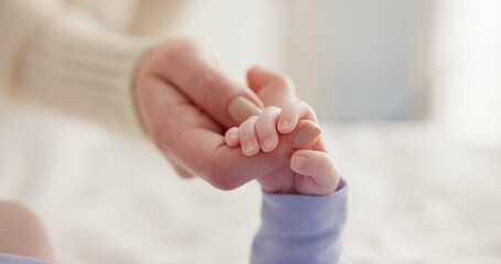 Sleeping, family and holding hands with baby on bed for bonding, love and relationship with infant. Adorable, care and closeup of parent with newborn for support, dreaming and protection at home - obrazy, fototapety, plakaty