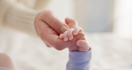 Sleeping, family and holding hands with baby on bed for bonding, love and relationship with infant....