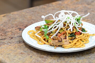 asian noodles with chicken and vegetables. restaurant menu