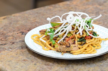 asian noodles with chicken and vegetables. restaurant menu