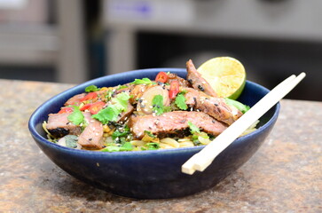 close up view of asian salad nam tok with noodles and beef	