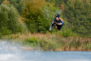 male wakeboarder performs reilly trick