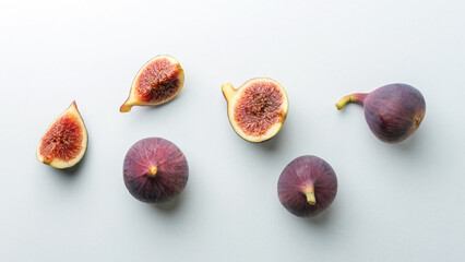 Composition with whole and cut figs on white background. Food concept.