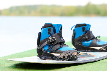 boots in mounts on wakeboarding boards in blue