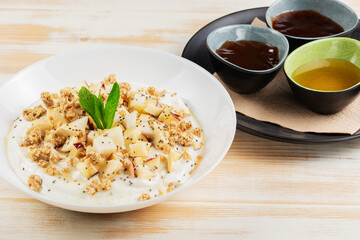 Yogurt, fruits and flakes with honey. Healthy Βreakfast concept.