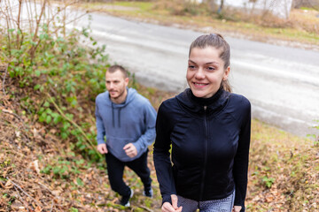 Happy Caucasian couple jogging in nature.
