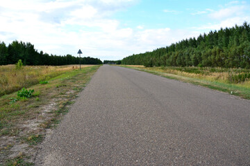 empty asphalt road going to horizon with blue sky and clouds copy space 