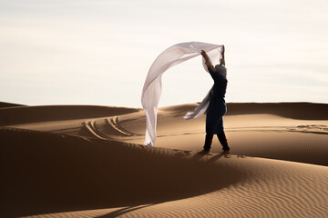 Man with wind in the desert