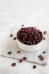 Organic Dried Cranberries in a Bowl, side view. Space for text.