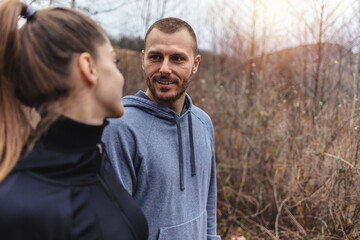 Obraz premium Cropped shot of two athletes standing outdoors. Portrait of a happy young couple out for a run.