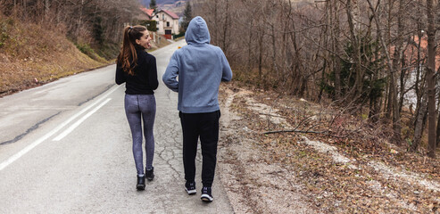Rearview shot of a young couple running together outdoors.