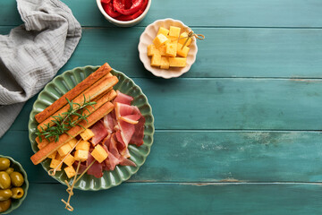 Slices of prosciutto or jamon. Antipasto Delicious grissini sticks with prosciutto, cheese,...