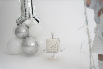 Fototapeta na wymiar First Birthday cake white and silver 1st birthday cake with copy space. stars theme first birthday cake. 