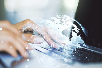 Fototapeta premium Double exposure of abstract programming language hologram with world map and hands typing on laptop on background, research and development concept