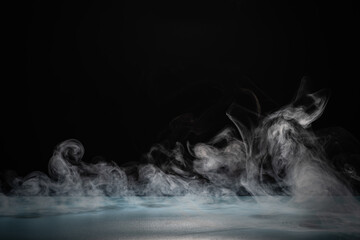 Swirling White Smoke Against a Dark Background in a Low-Light Studio Setting