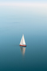 Calm Sea with Small Sailing Boat: Cinematic Photo
