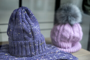 Closeup of purple woolen hats in a fashion store showroom