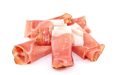 Rolled slices of Speck on white background. It is a smoked pork belly from the Tyrol and german tradition and then spread with many variants throughout Europe.