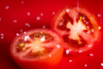 Tomatoes being sprinkled with salt. 