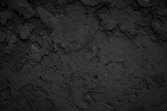 Black or dark gray rough grainy stone or sand plaster texture background