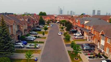 Road weaving through American single-story homes, capturing essence of American Dream. Scenic road...
