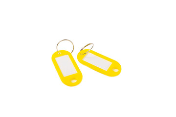 Plastic keychain of different colors with a place for a signature isolated on a white background....