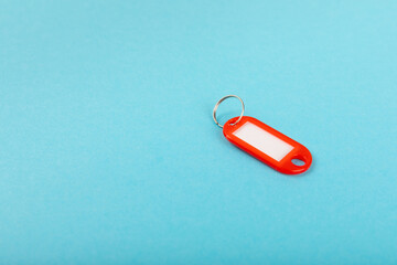 Plastic key ring in different colors with a place for a signature on a bright colored background. Bunch of keys with keychain. Mock-up keychain.Copy space.Concept for renting and selling real estate.