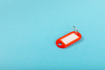 Plastic key ring in different colors with a place for a signature on a bright colored background. Bunch of keys with keychain. Mock-up keychain.Copy space.Concept for renting and selling real estate.