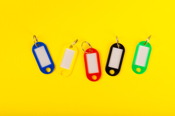 Plastic key ring in different colors with a place for a signature on a bright colored background....