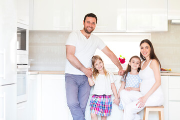 Adorable young big family embracing on kitchen