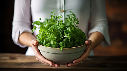 Woman holding bowl with fresh herbs. Healthy lifestyle