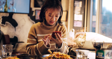 Japanese woman, smartphone and healthy food in restaurant for dinner, nutrition and happy on social...