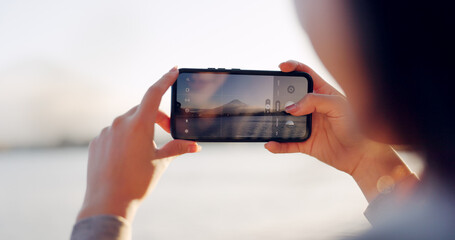 Hands, phone and photography by lake, mountain and nature with landscape, horizon and outdoor...