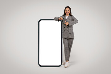 Businesswoman with giant phone for app presentation