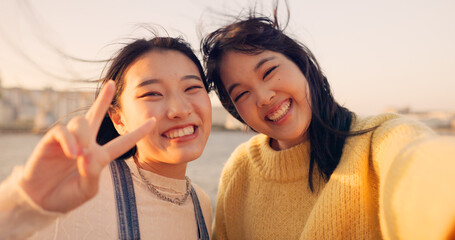 Women, friends and selfie at sea holiday in Japan for travel experience, adventure or happy. Female...