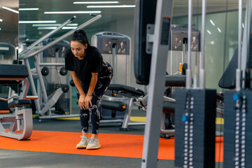 Fototapeta na wymiar young girl in sportswear in the gym doing leg exercises before training healthy lifestyle