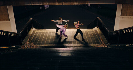 Women, group and dancing on stairs in city, moving body and freedom for street performance in...