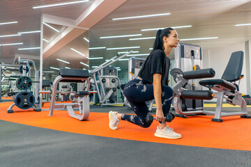 Fototapeta na wymiar young girl in sportswear in gym doing lunges with dumbbells training healthy lifestyle